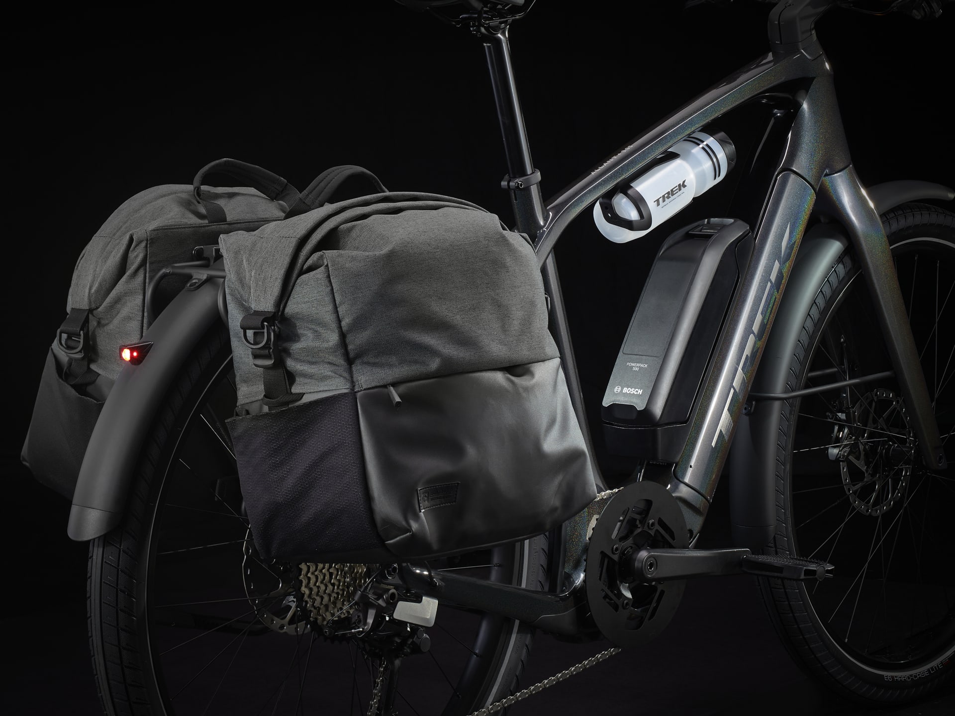 Trek Allant+ with panniers mounted on its rear rack and a water bottle under the top tube