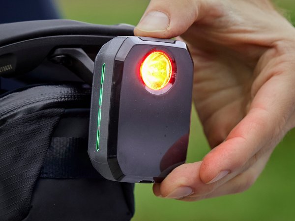 Hand holding the compact Trek CarBack rear radar light