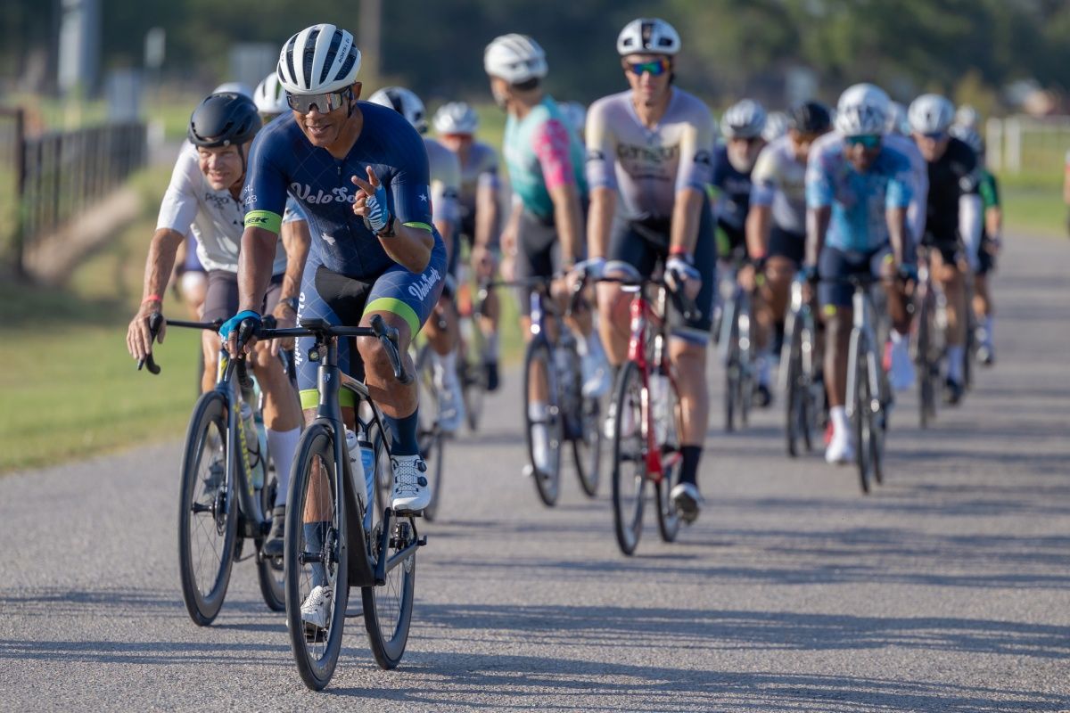 Large group of cyclists riding together on a road during the Trek 100 Texas ride