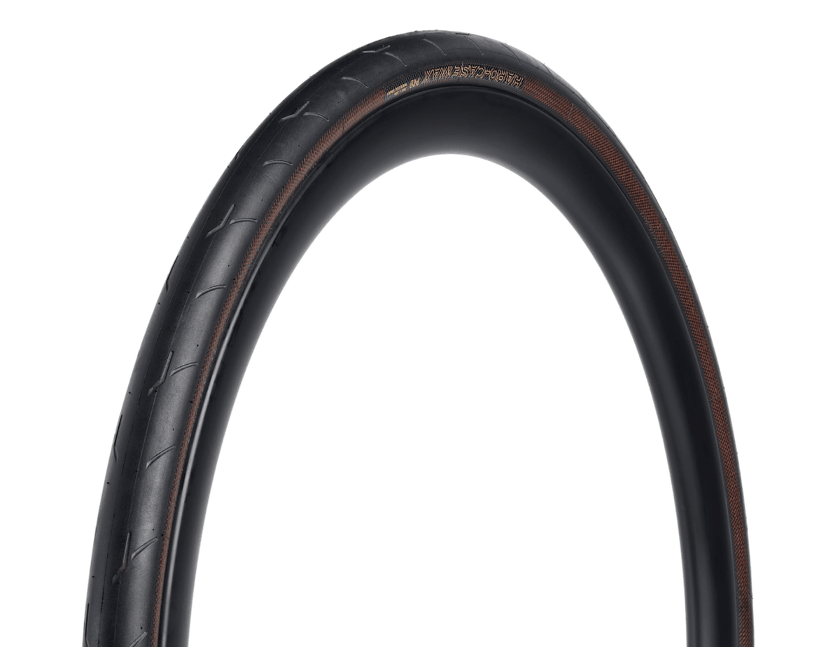 The Bontrager Hard-Case Max Pro TLR Road Tire, a black road tire with tan sidewalls.