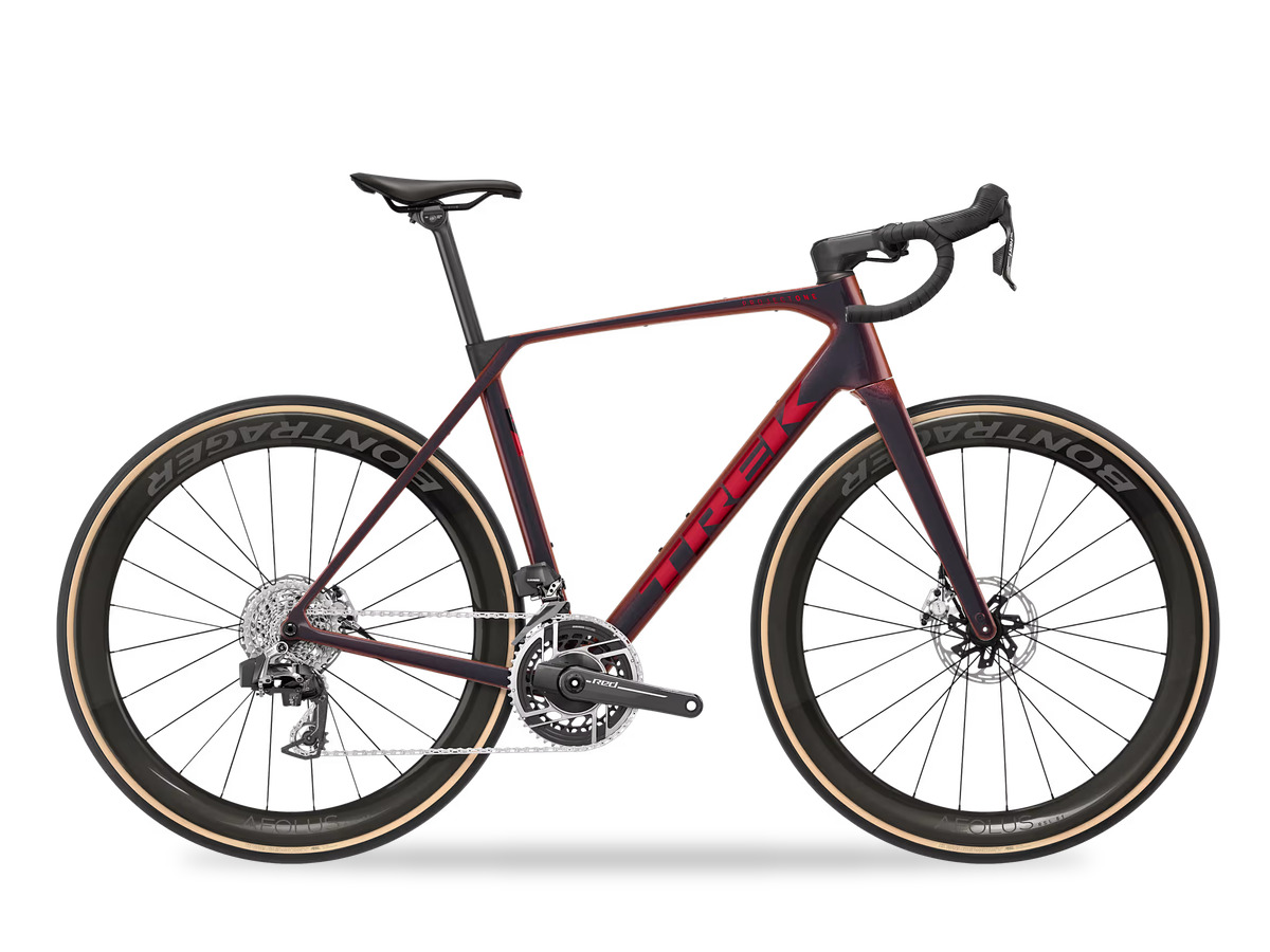 Trek Domane carbon road bike in dark red with tan sidewall tires