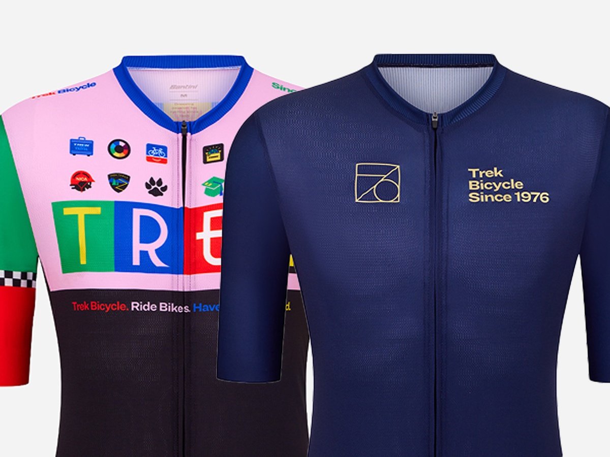 Trek First 50 jersey in pink with colorful patches beside the navy No. 76 jersey